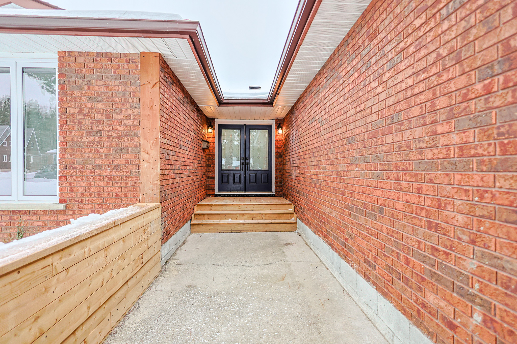 a living room filled with furniture and a kitchen