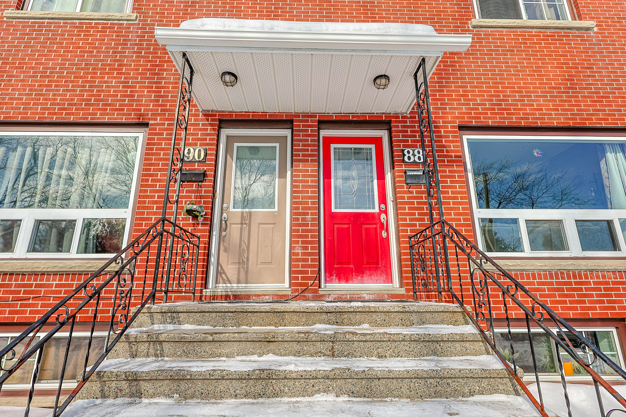 a living room filled with furniture and a kitchen