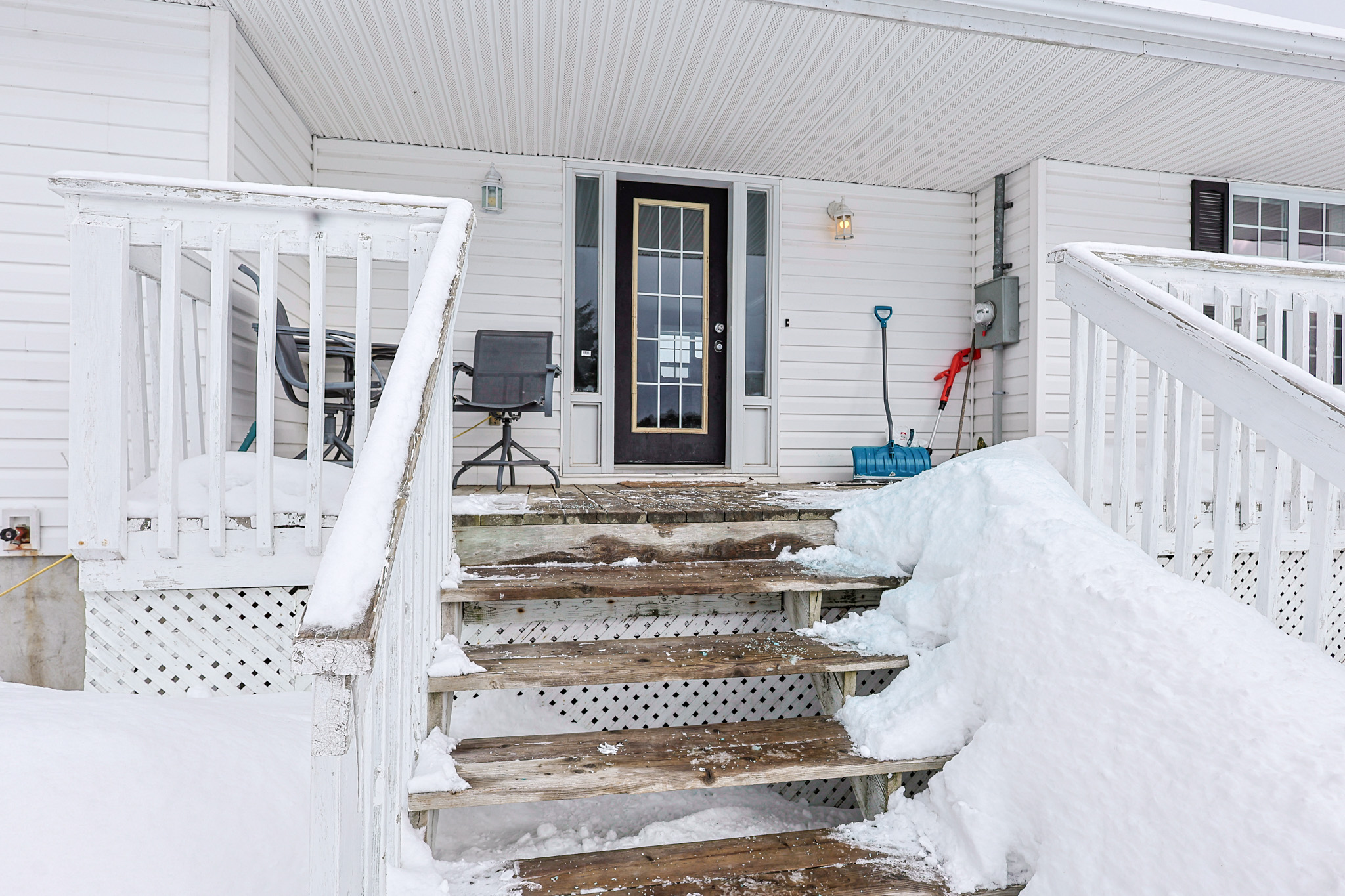 a living room filled with furniture and a kitchen