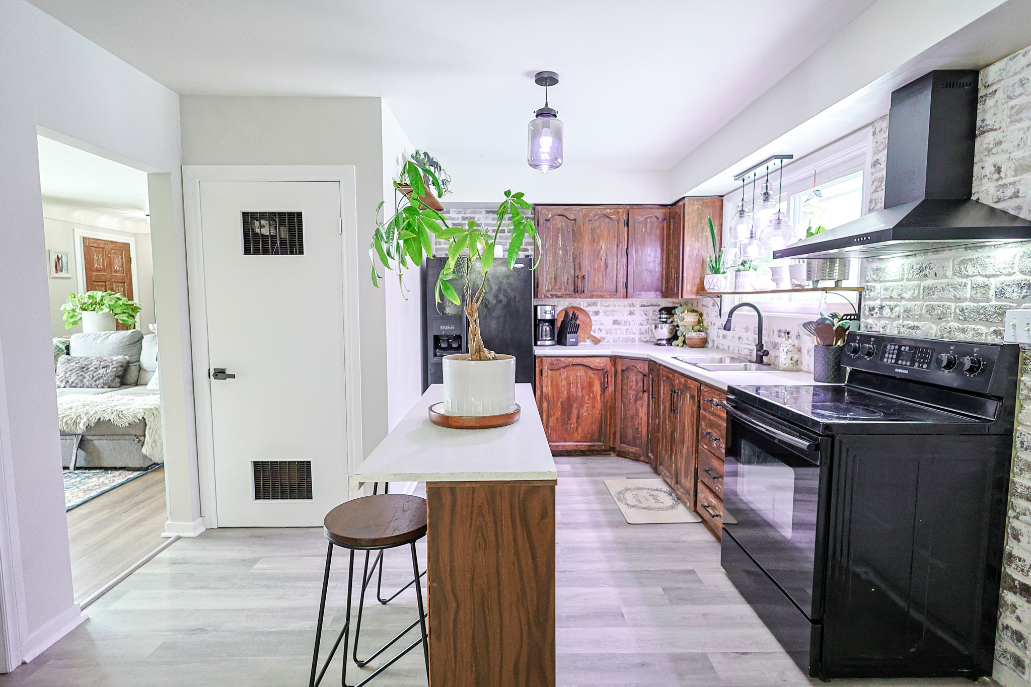 a living room filled with furniture and a kitchen