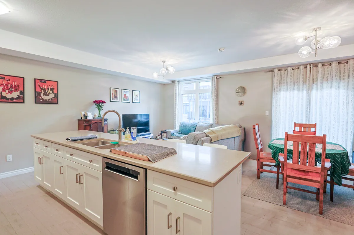 a living room filled with furniture and a kitchen