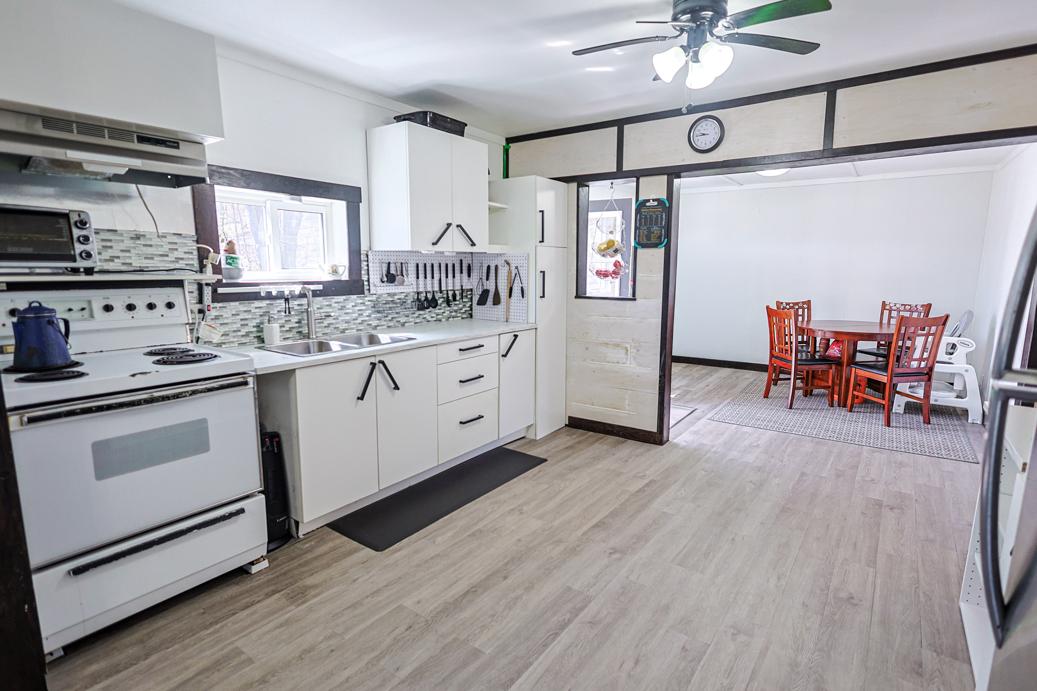 a living room filled with furniture and a kitchen