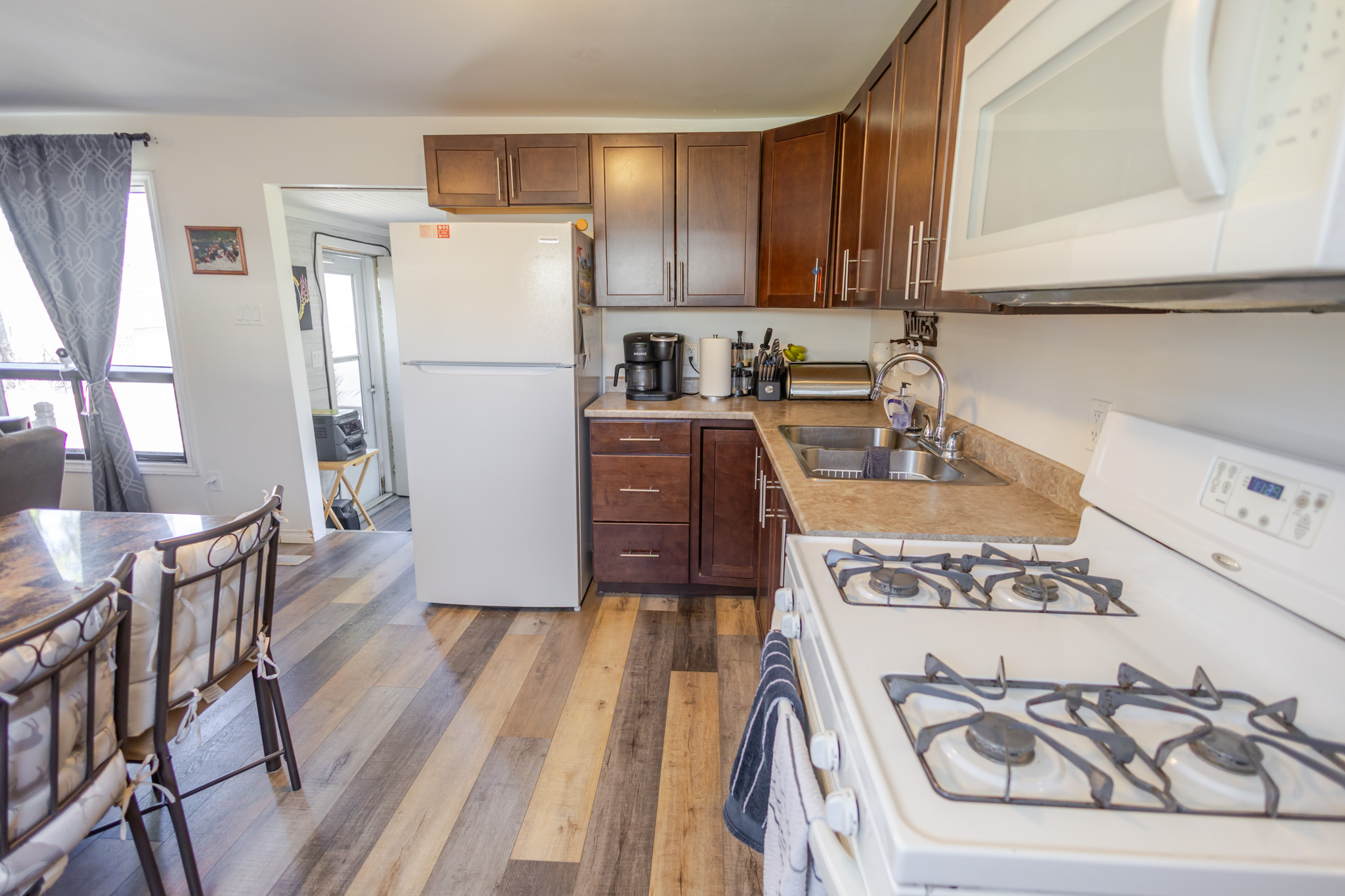 a living room filled with furniture and a kitchen