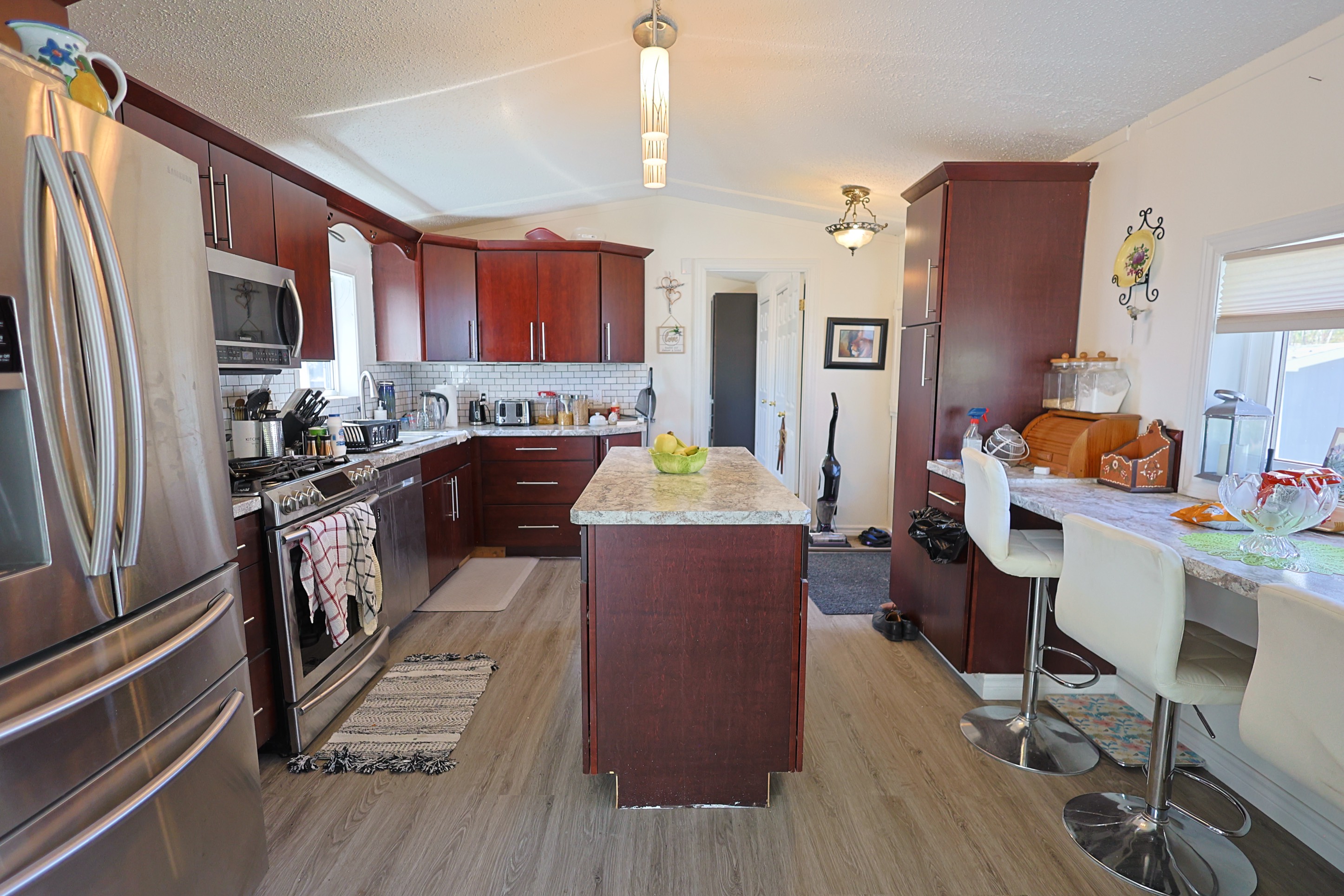 a living room filled with furniture and a kitchen
