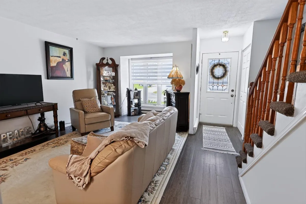 a living room filled with furniture and a kitchen