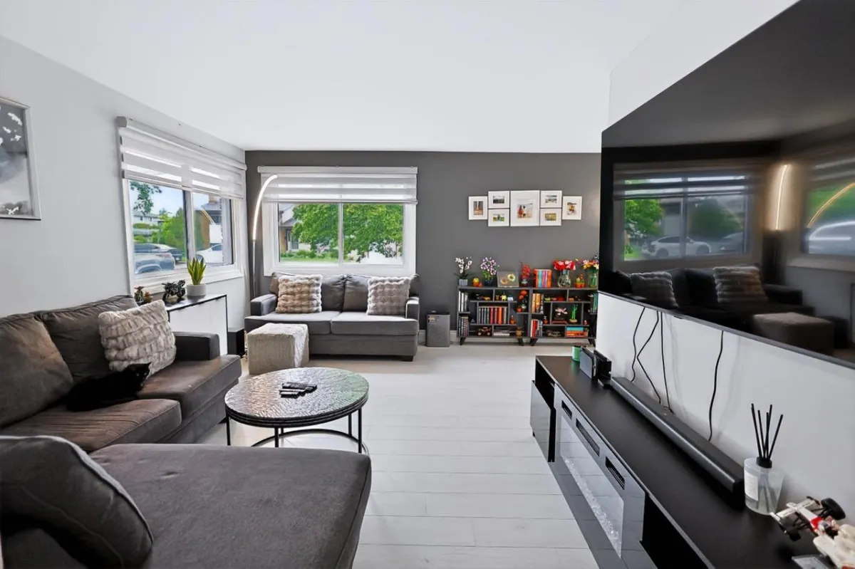 a living room filled with furniture and a kitchen