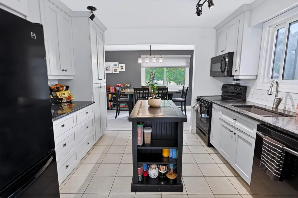 a living room filled with furniture and a kitchen
