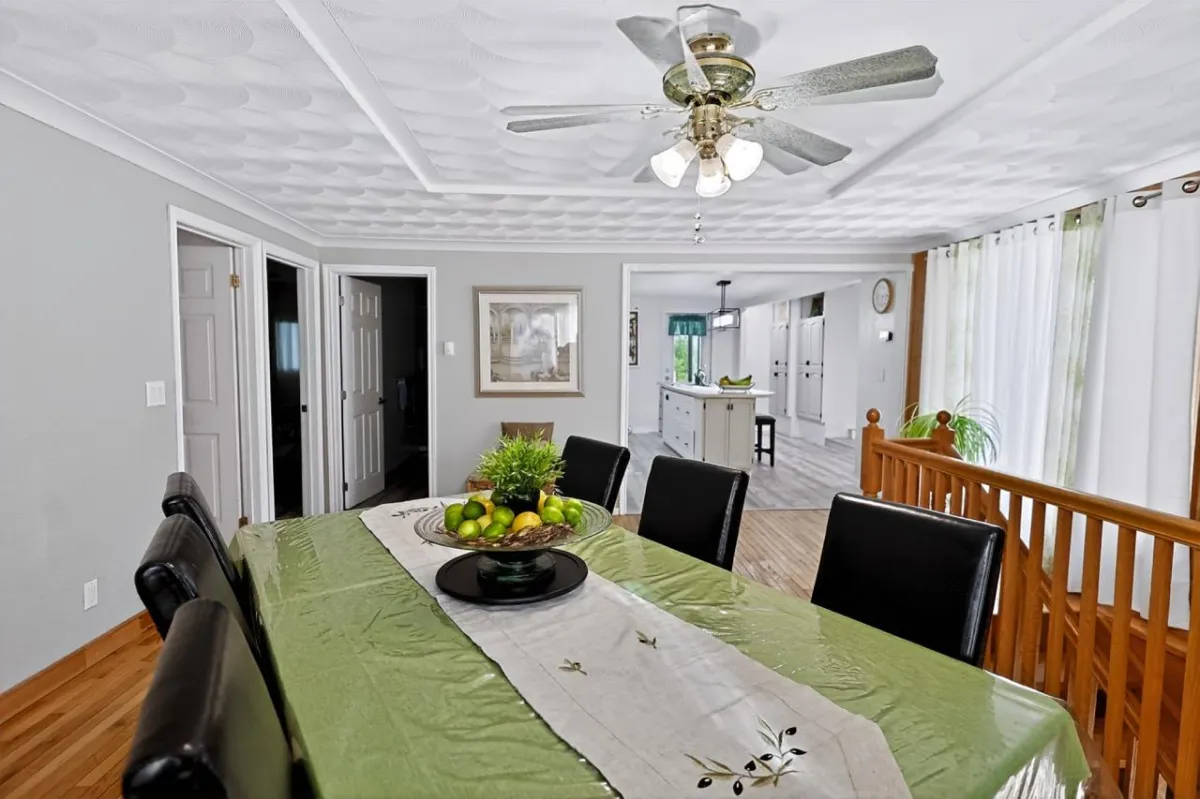 a living room filled with furniture and a kitchen