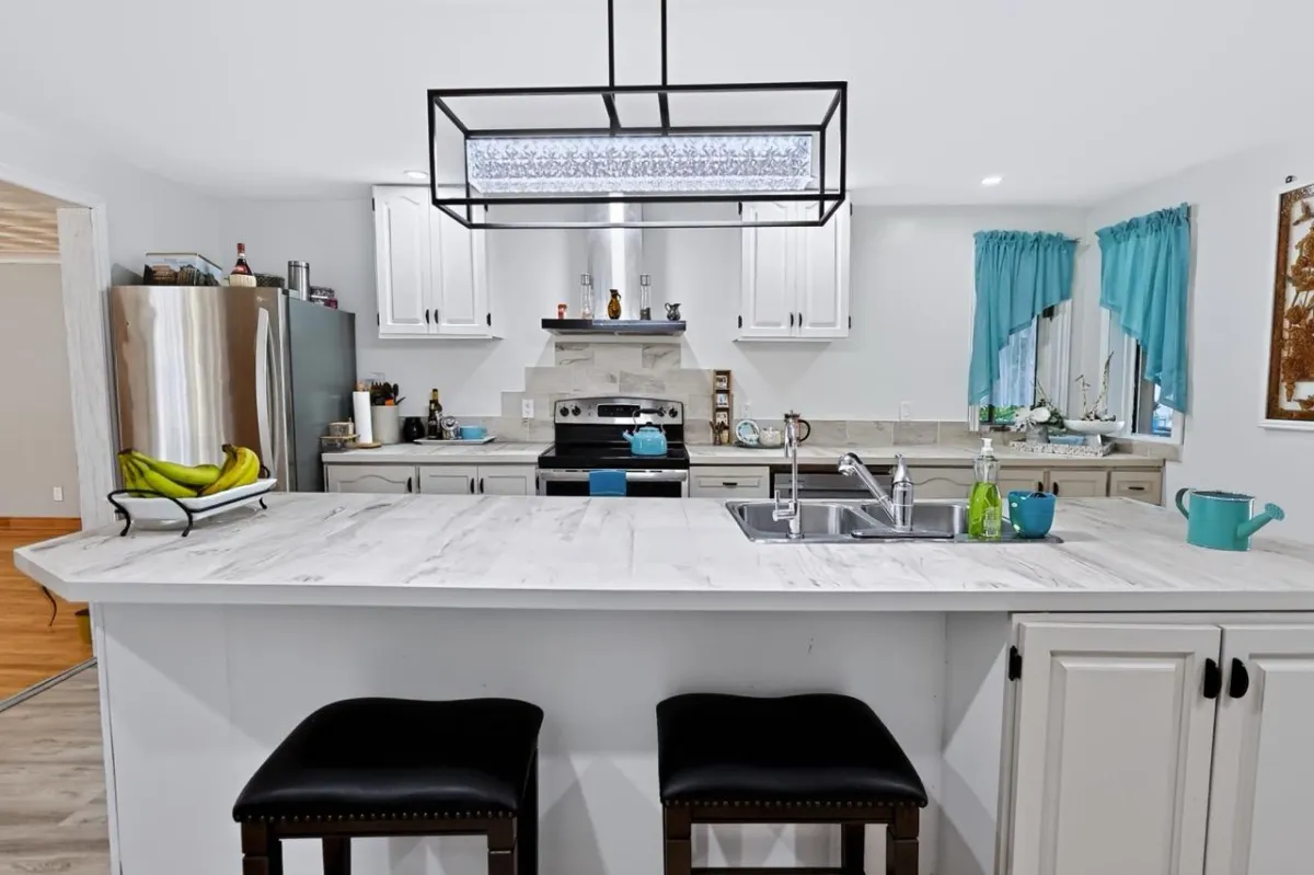 a living room filled with furniture and a kitchen