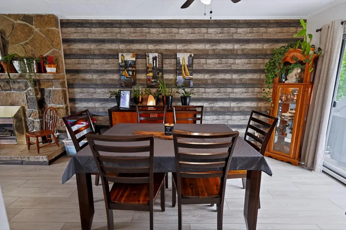 a living room filled with furniture and a kitchen