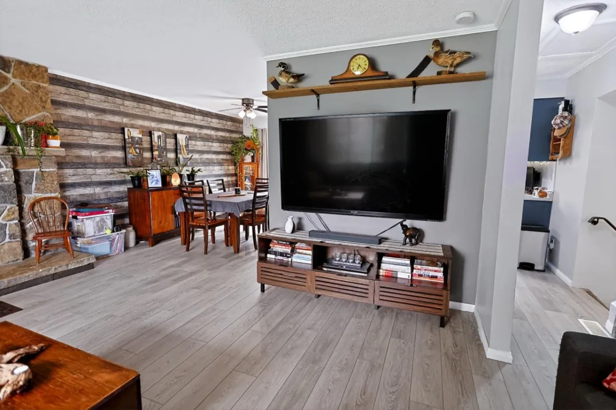 a living room filled with furniture and a kitchen