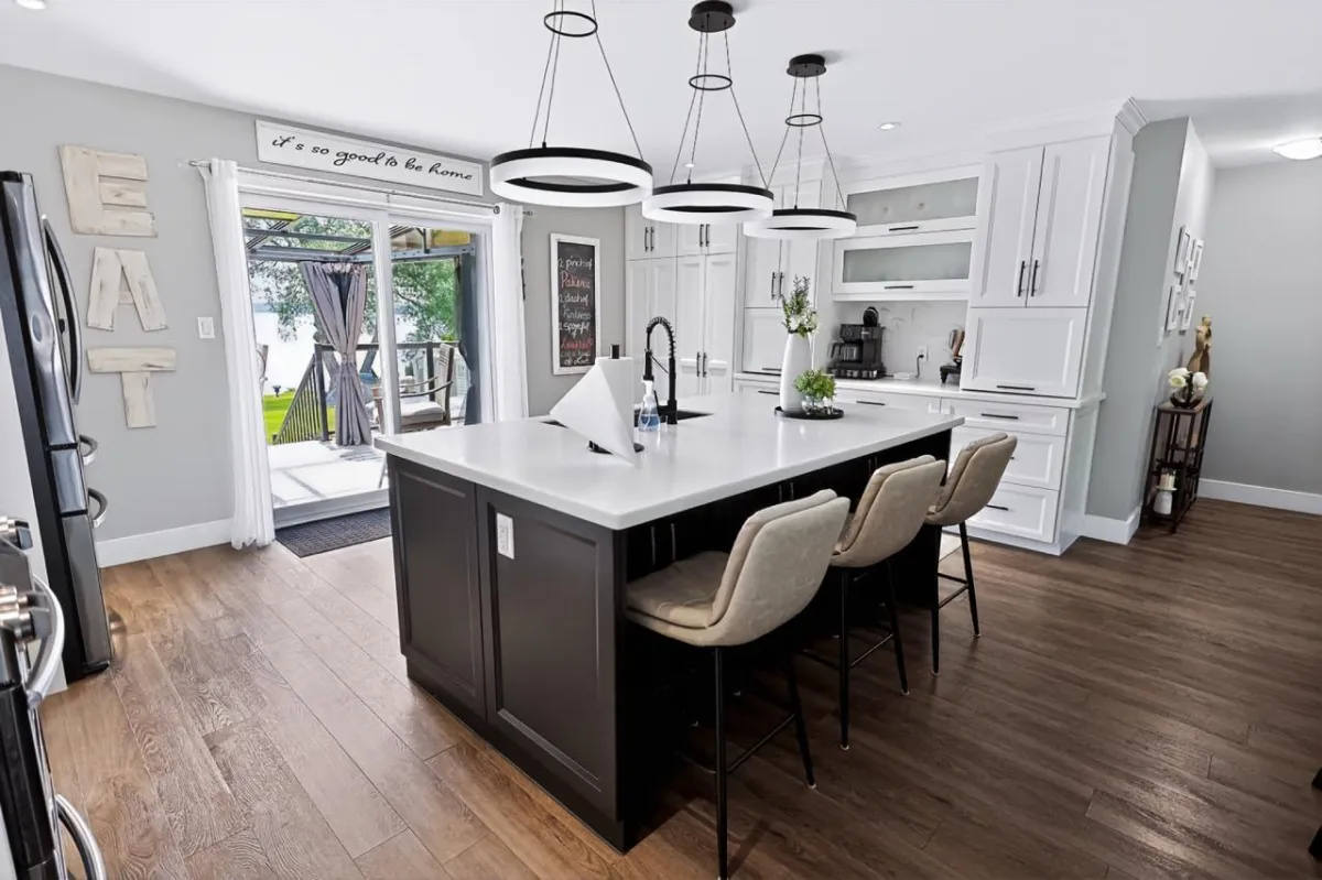 a living room filled with furniture and a kitchen