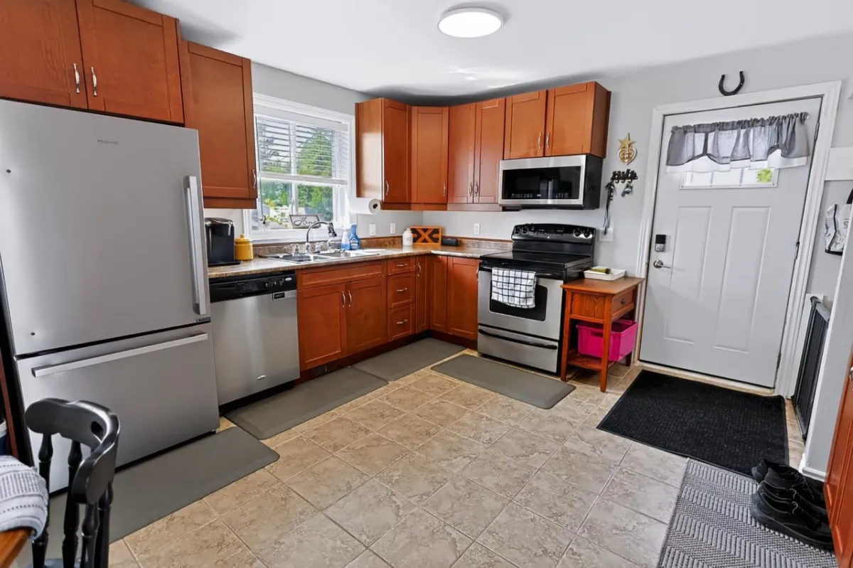 a living room filled with furniture and a kitchen