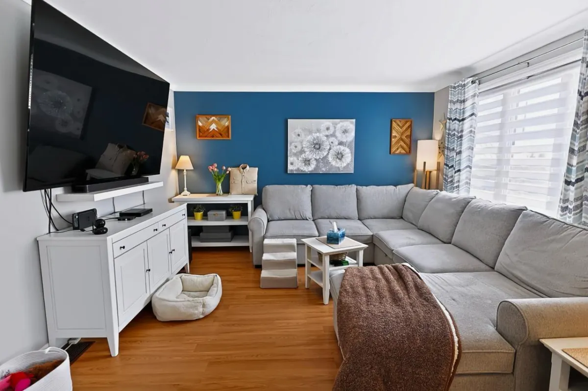 a living room filled with furniture and a kitchen