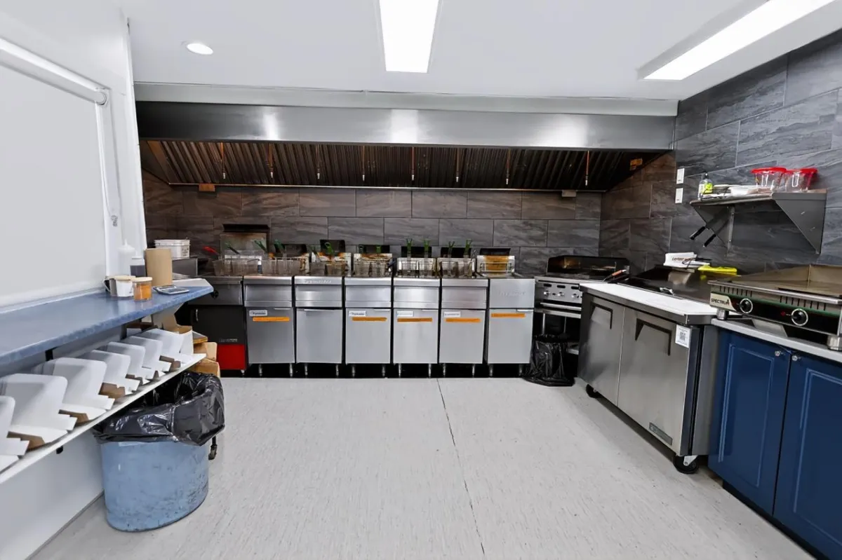 a living room filled with furniture and a kitchen