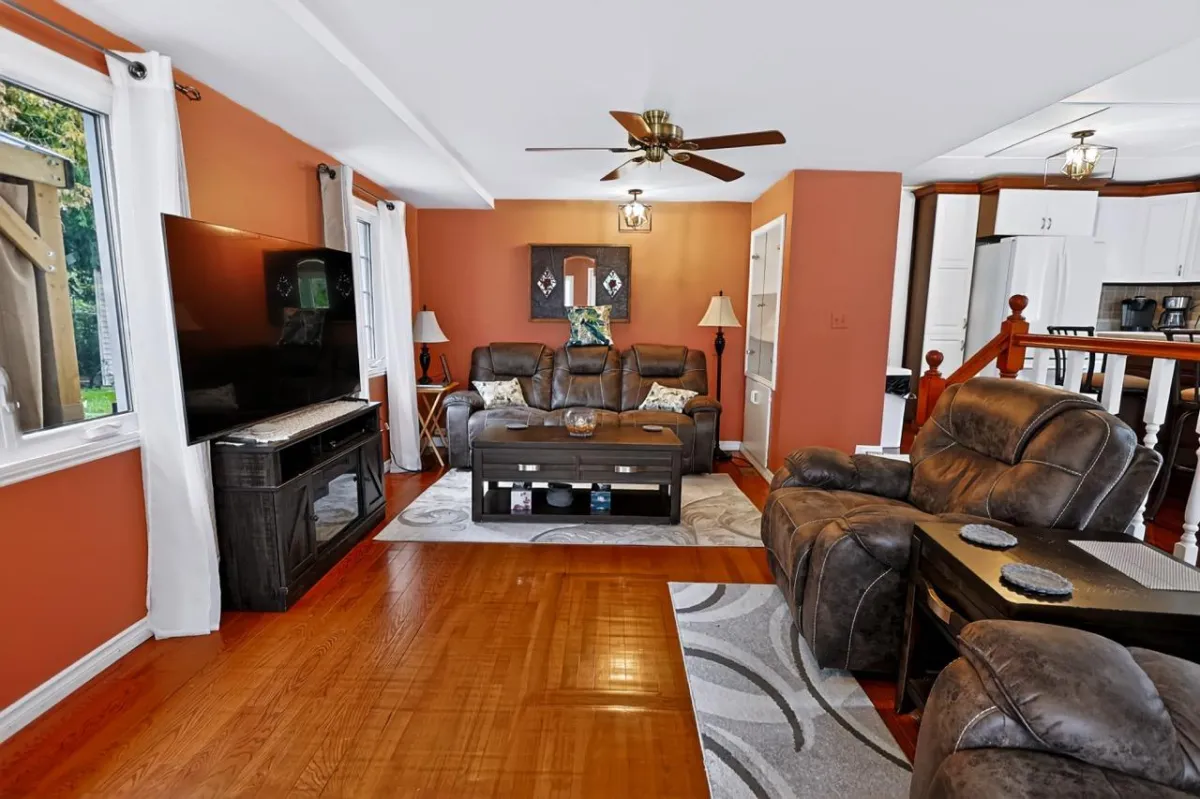 a living room filled with furniture and a kitchen