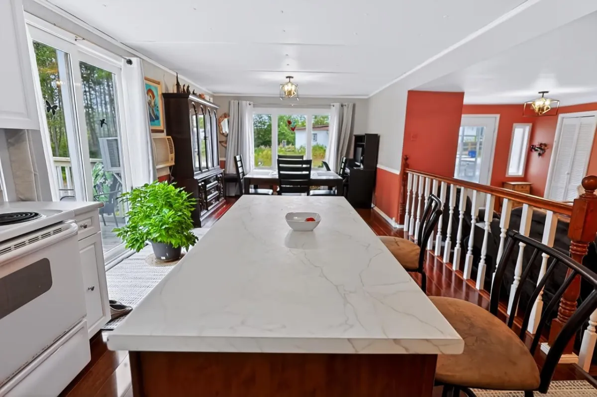 a living room filled with furniture and a kitchen