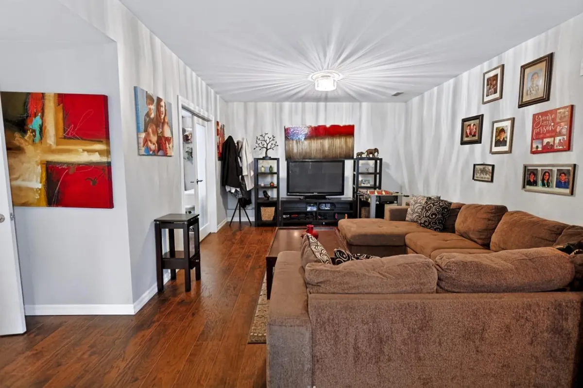 a living room filled with furniture and a kitchen