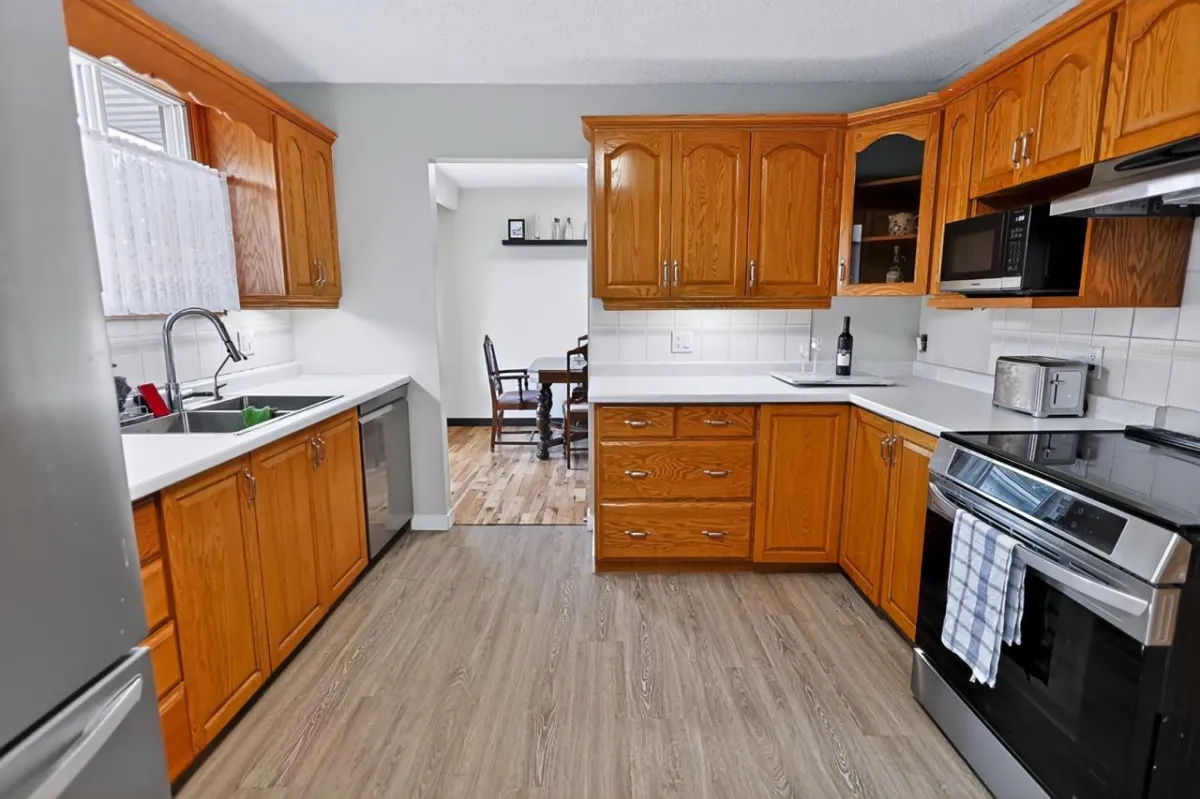 a living room filled with furniture and a kitchen