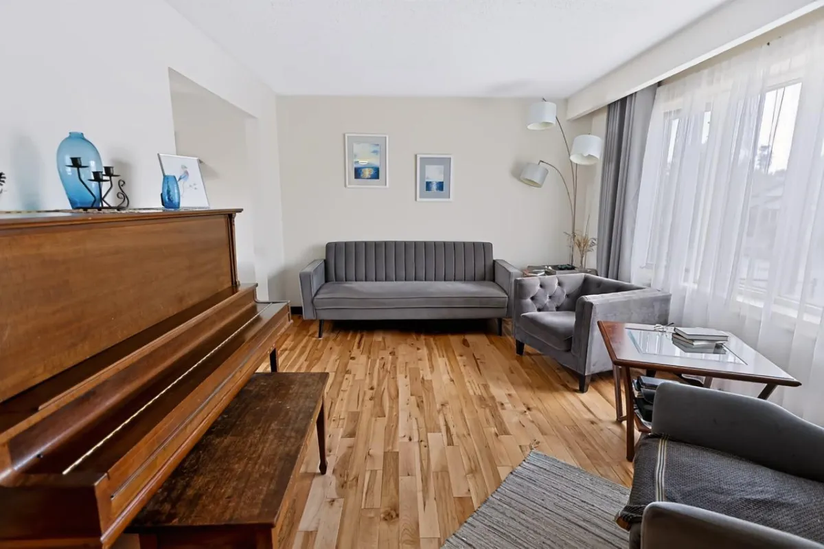 a living room filled with furniture and a kitchen
