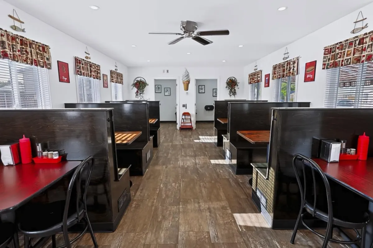 a living room filled with furniture and a kitchen