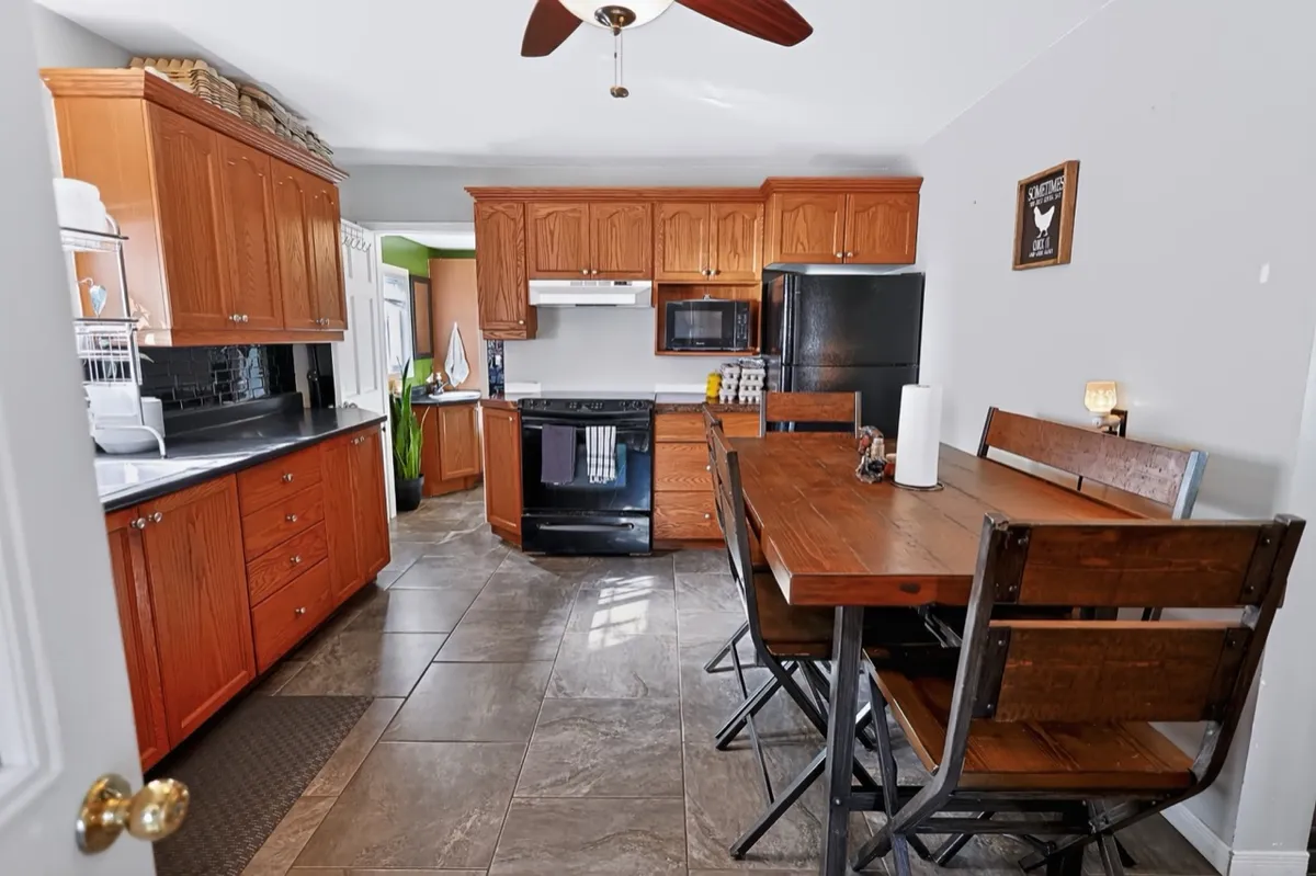 a living room filled with furniture and a kitchen