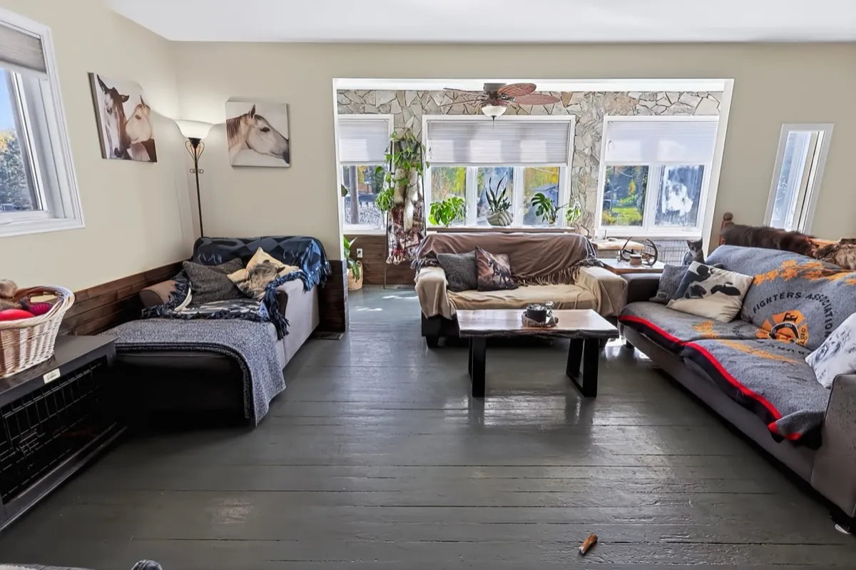 a living room filled with furniture and a kitchen