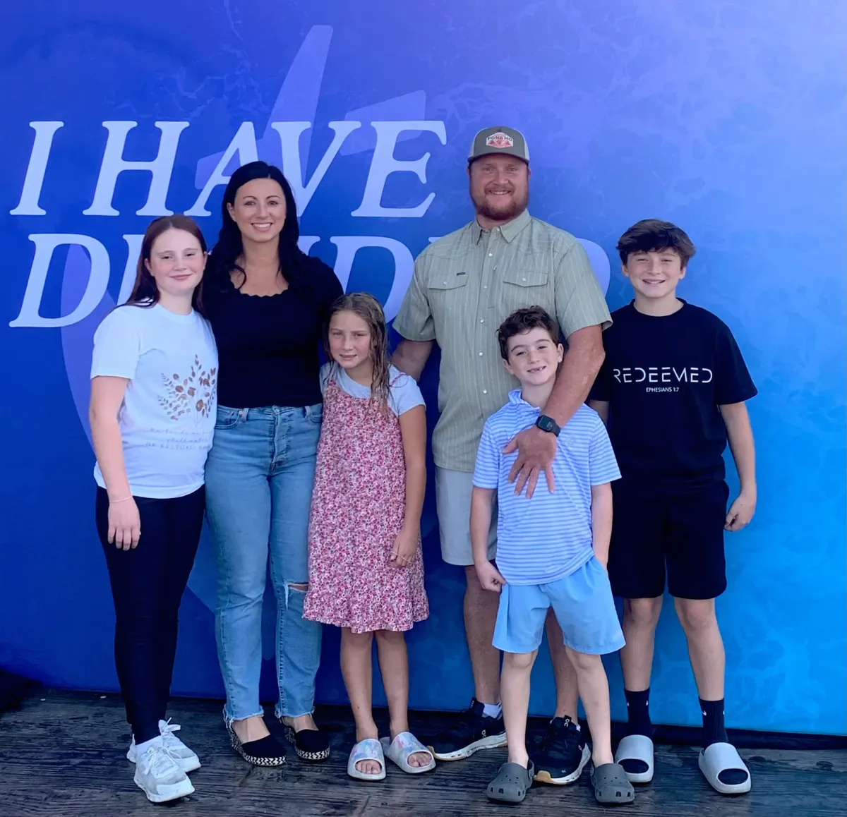 Family standing next to clean trash cans after professional trash can cleaning service in McKinney Texas