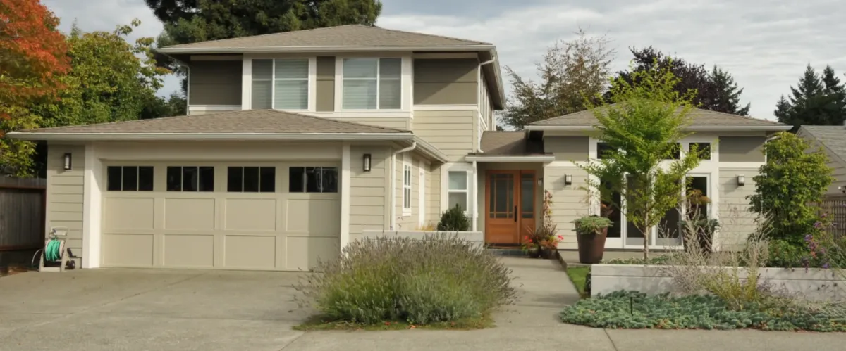 Front view of a suburban home with a well-kept lawn and clean driveway