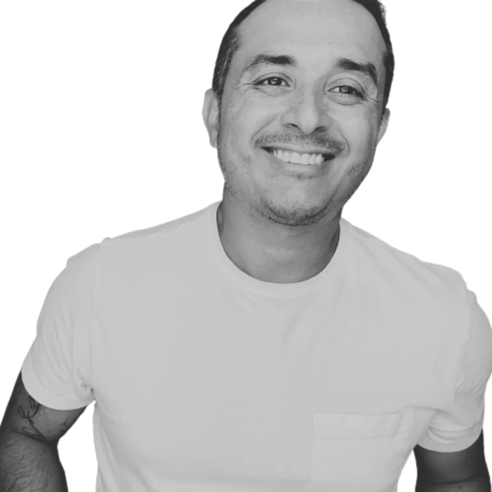 Abel Macias, demand generation strategist and funnel architect, smiling in a black and white portrait.
