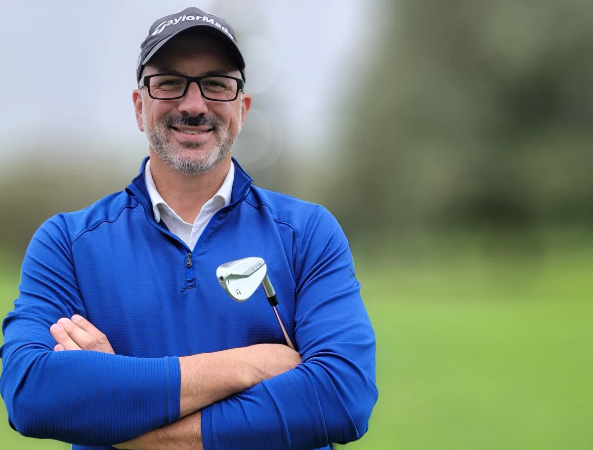 bryan zurawski pga pro closeup with golf club in arms