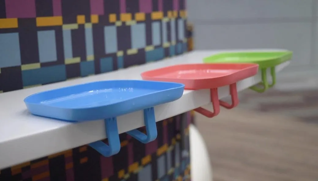 a baby eating from a stayplayt attachable baby plate
