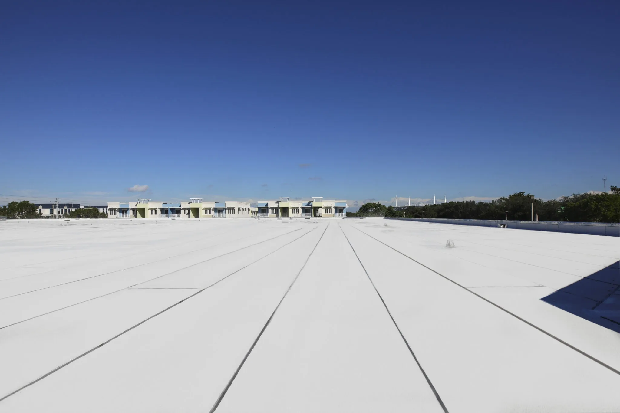 a white roof with persony buildings in the background