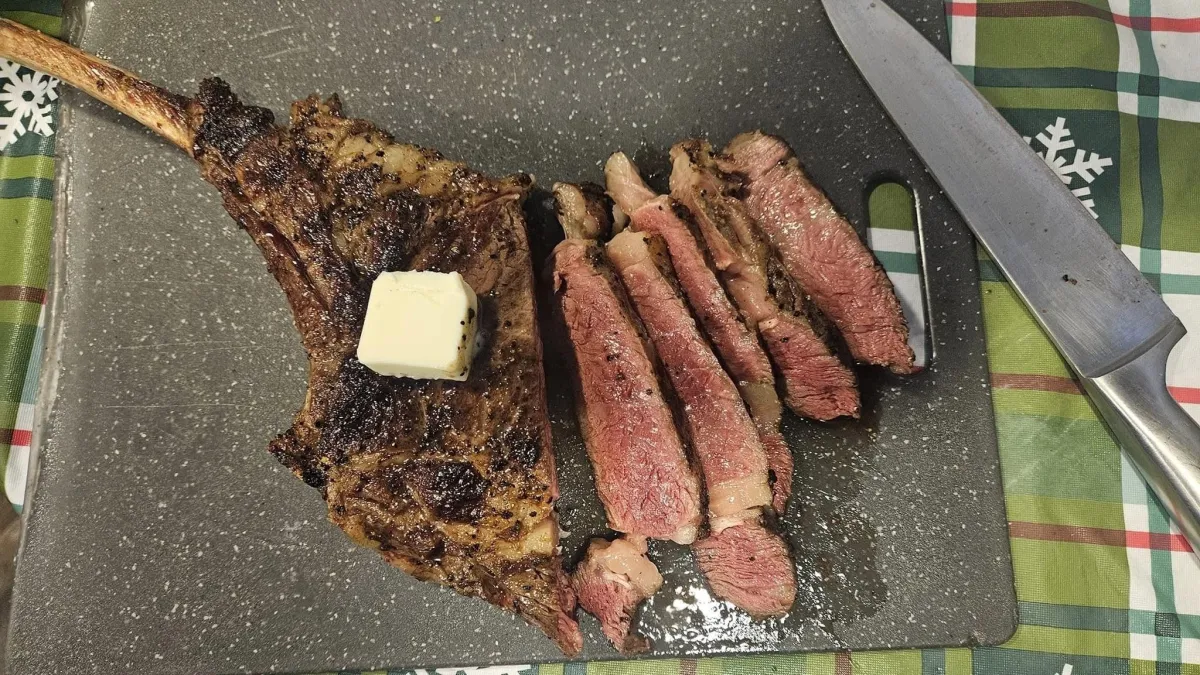a steak and asparagus on a cutting board