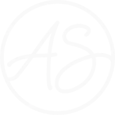 Aurora Collective circular monogram badge in deep magenta and white.