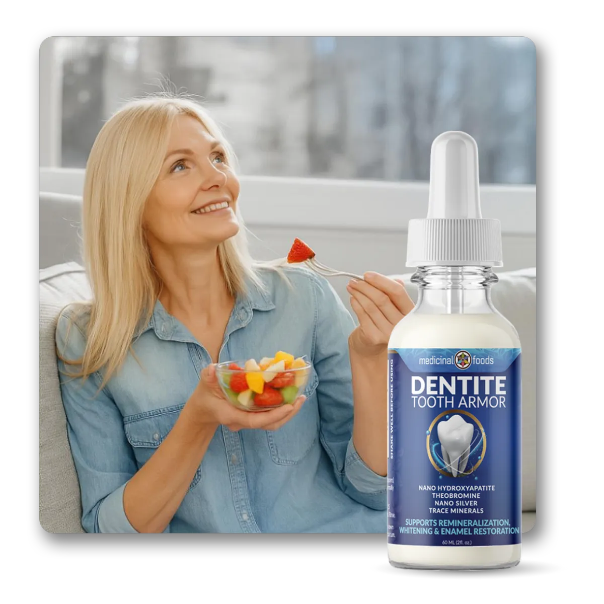 Smiling middle-aged woman holding a bowl of fresh fruit while sitting in natural light, with a Dentite Tooth Armor bottle placed in the foreground to suggest daily use for sensitivity relief and enamel support after brushing.
