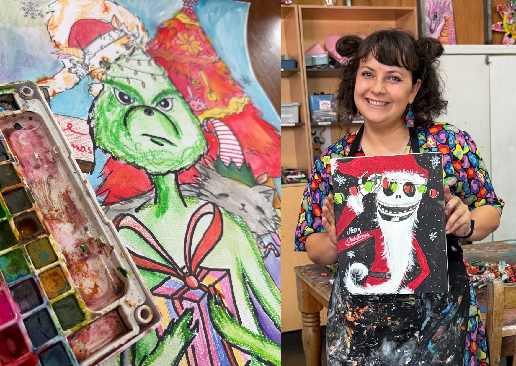 A smiling female art teacher in her late 20s, wearing a green apron, kneels beside a group of three children aged 5 to 8, who are painting a large collaborative Christmas mural on an easel. The studio background is filled with colorful student artwork and natural light, creating a welcoming, creative atmosphere.