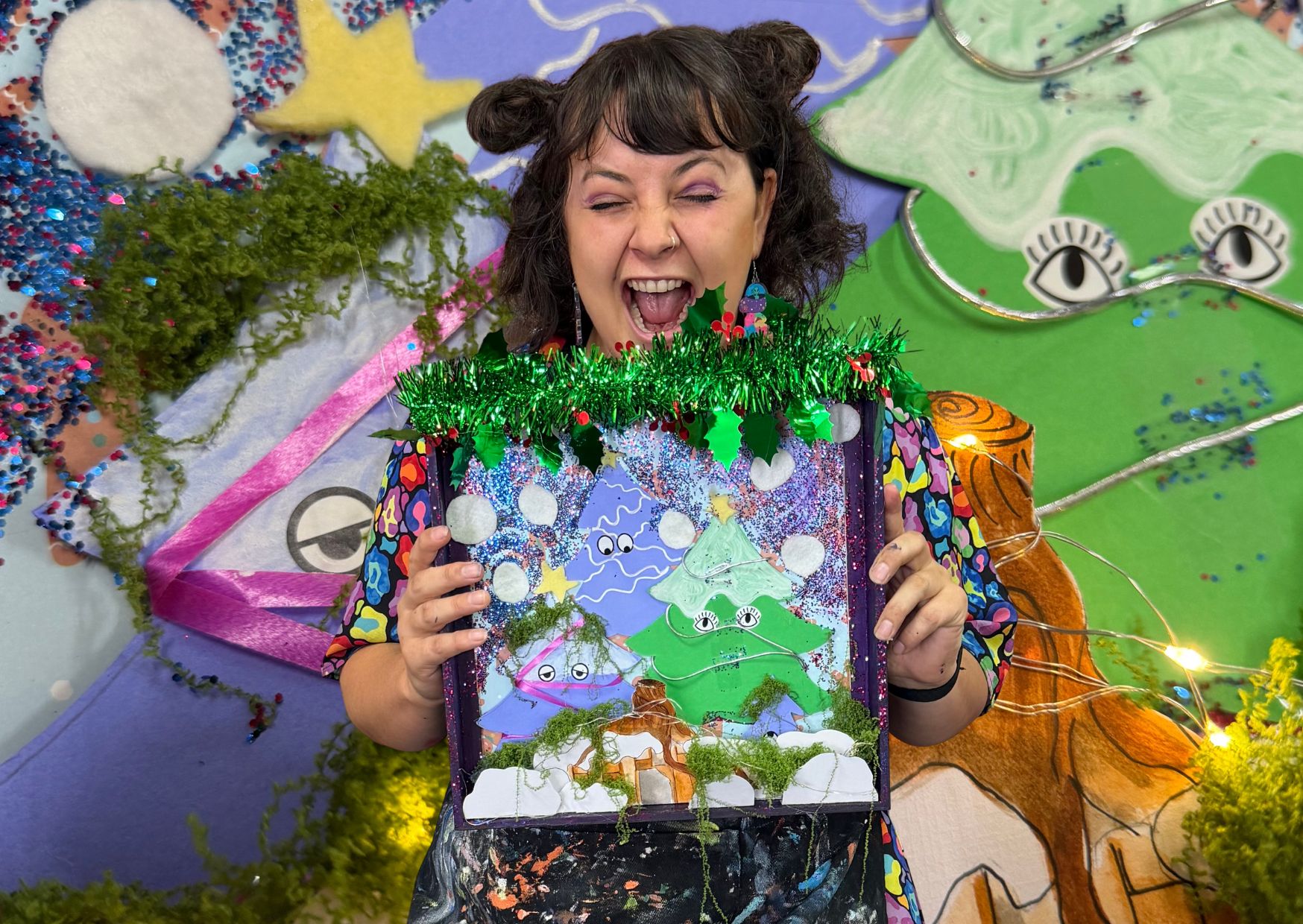A joyful family of four, two parents and two children, gathered around a table covered in colorful art supplies, painting Christmas ornaments together in a sunlit studio decorated with twinkling lights and festive garlands. The children, ages 6 and 9, are laughing as they show off their painted creations. The parents, both in their 30s, smile warmly, creating a scene full of holiday cheer and creativity.