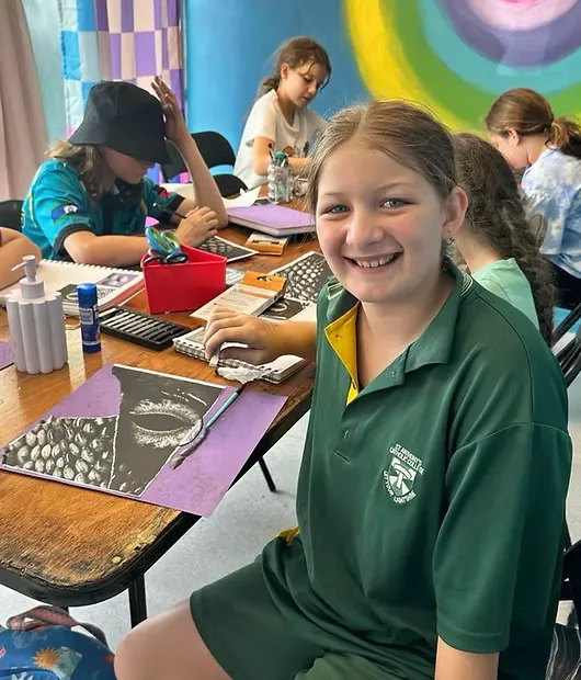 Square photo of two children sharing a large canvas, sweeping brushstrokes and smiles, candid wide-angle cropped for card hero image.