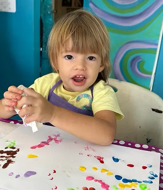 Square image of kids mixing pastels and watercolors, playful drips and textures, bright studio light emphasizing creative mess and delight.