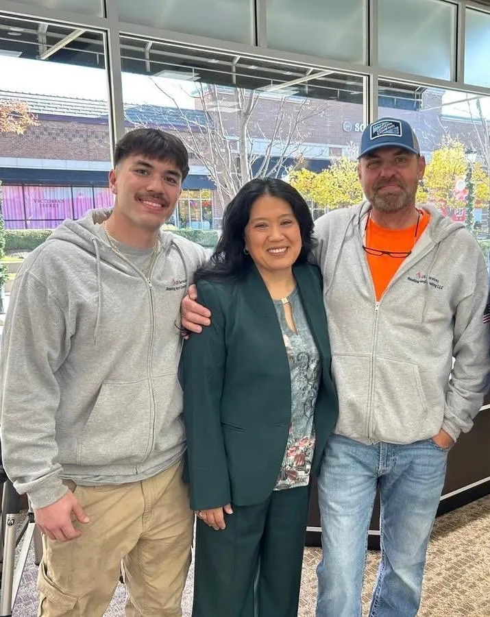 a couple of men standing on top of a roof