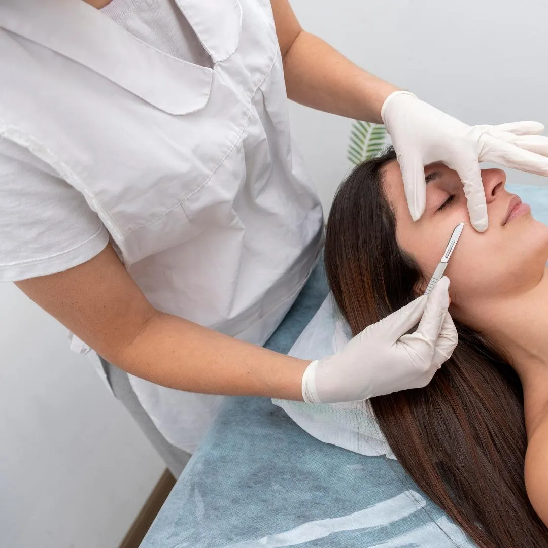 Dermaplane treatment being performed on a client
