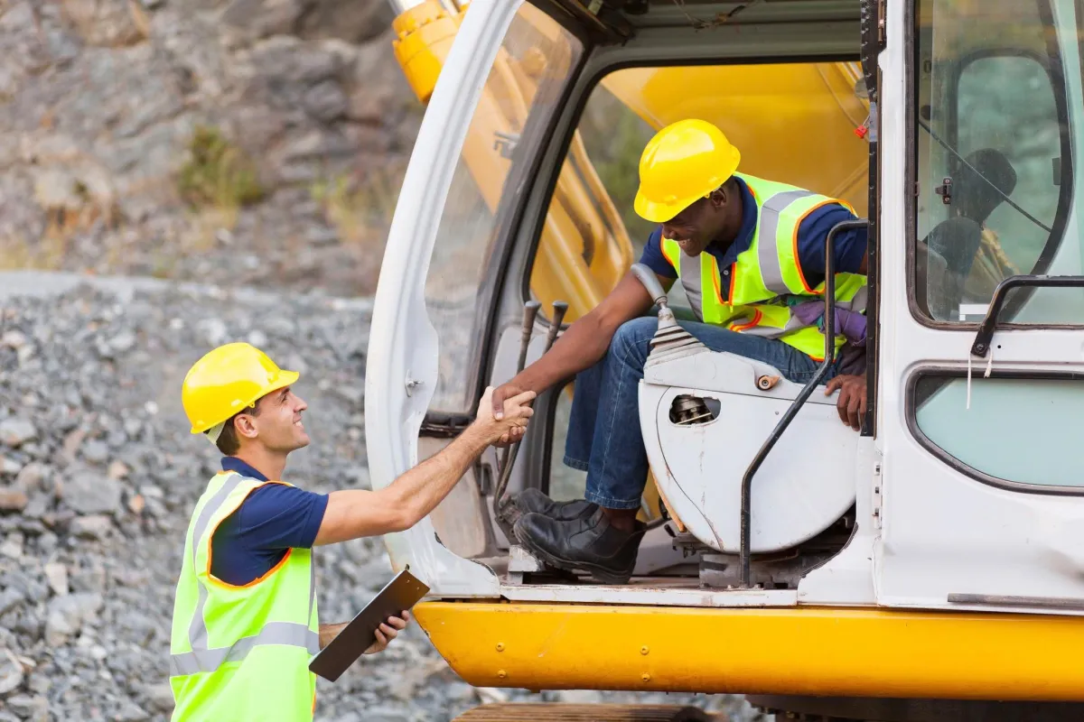 Construction manager, speaking with equipment operator