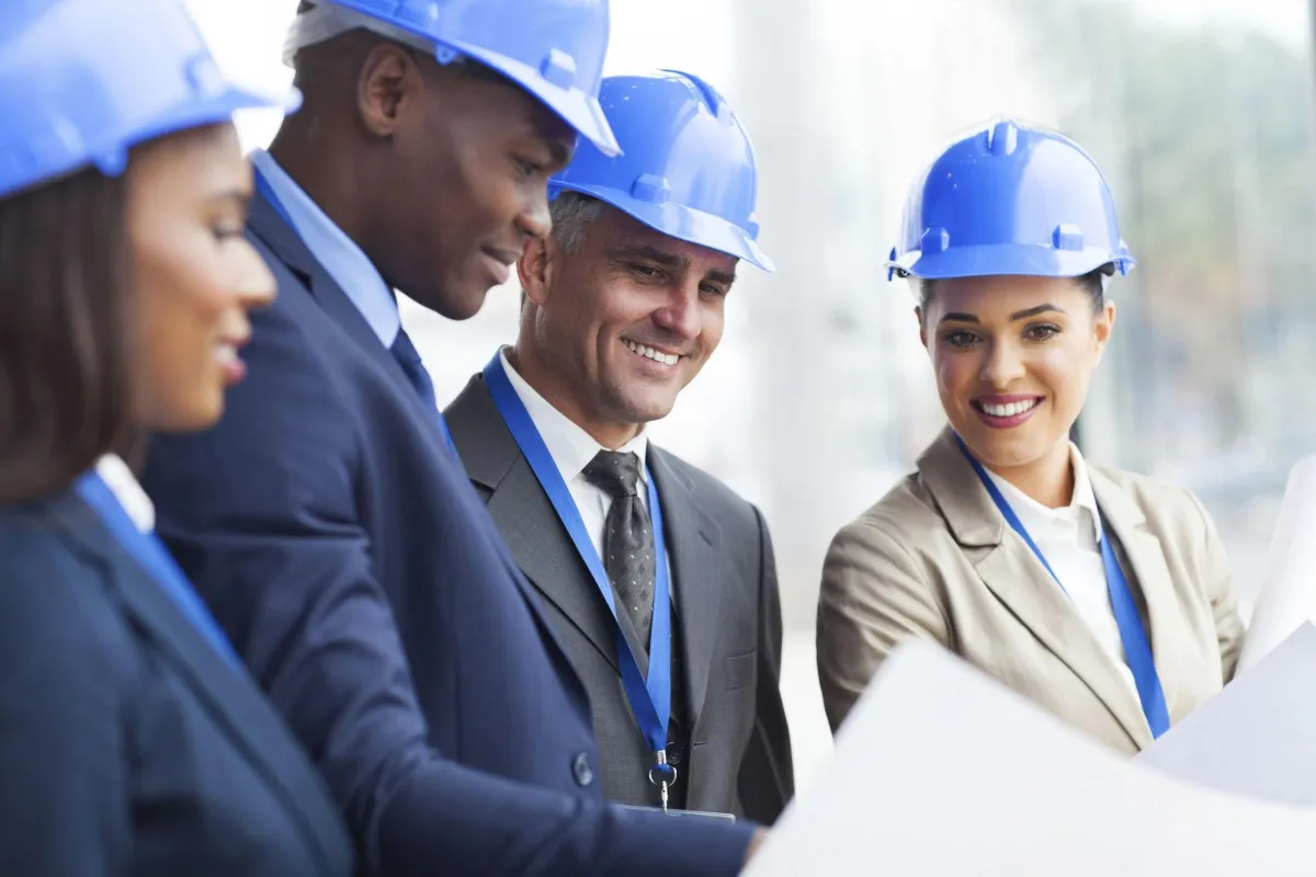 business people looking over blueprint