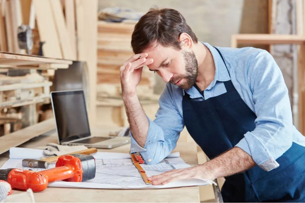 confused builder struggling with a measurement