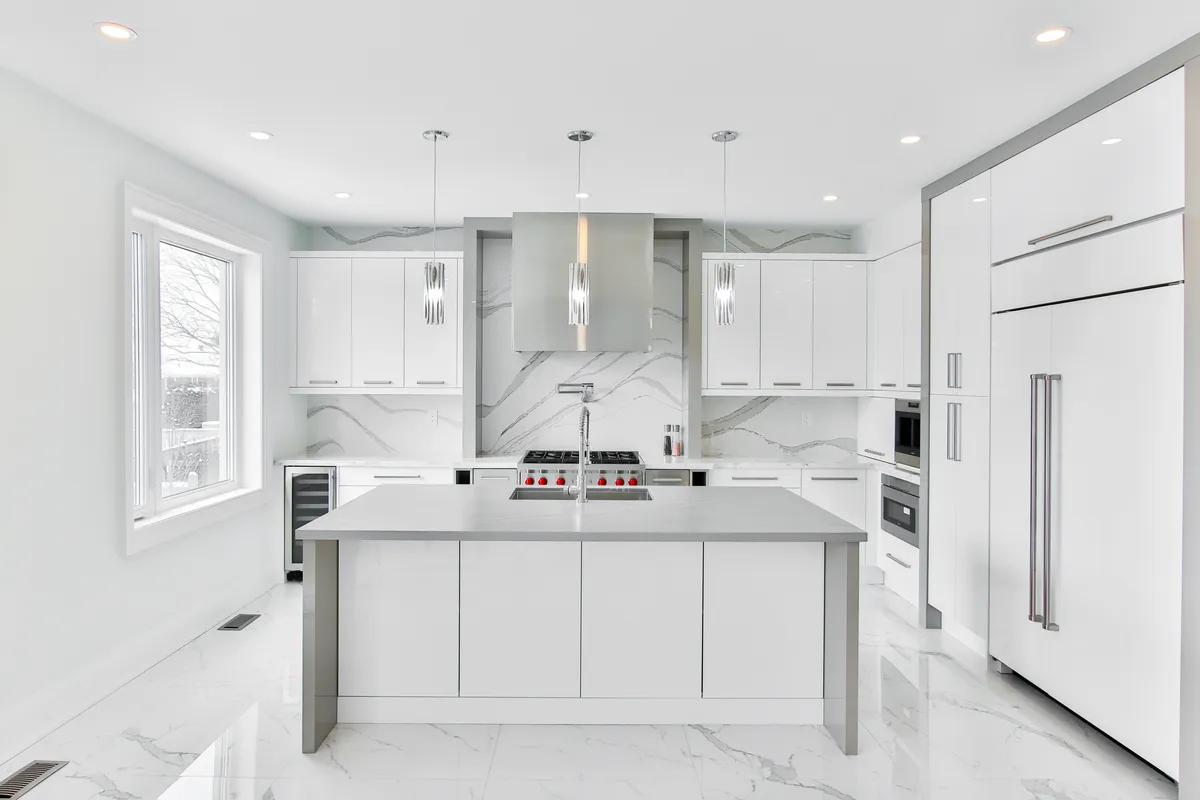 Bright white kitchen with large quartz island