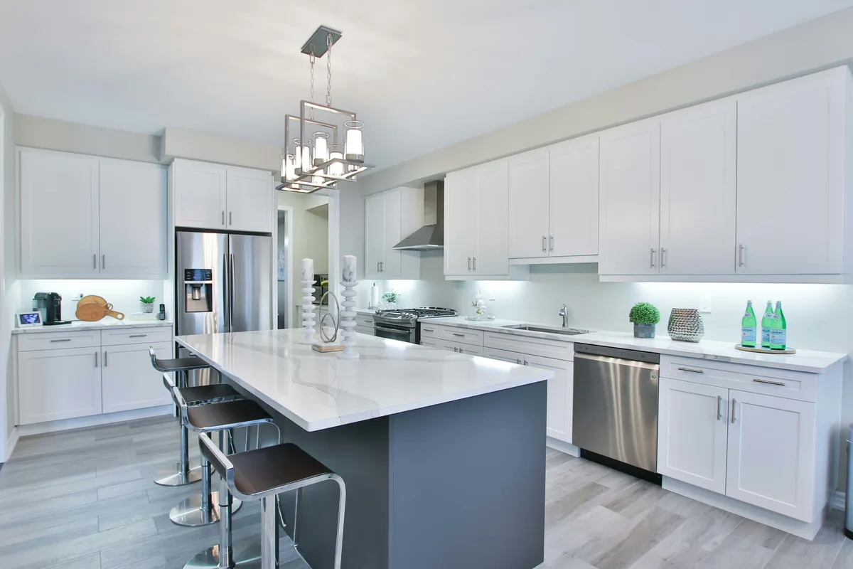 Modern kitchen with white island and pendant lighting