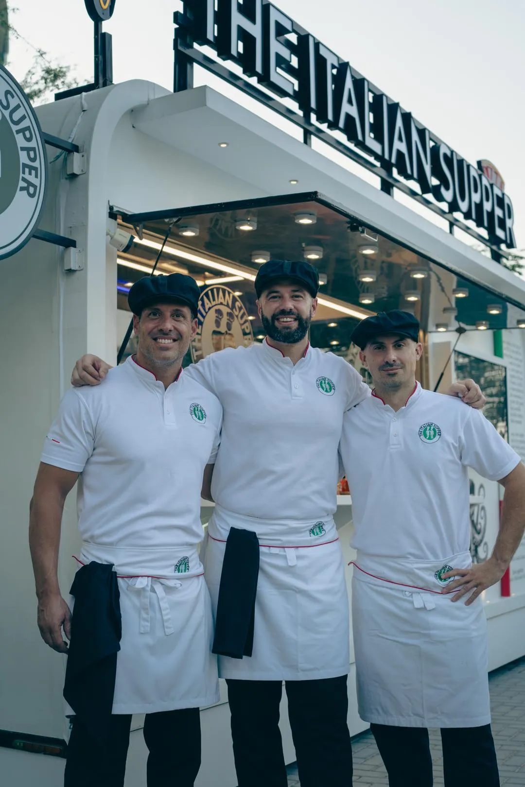 The three Italian founders of The Italian Supper food truck in Dubai, serving authentic Italian pizza, pasta, and desserts in Jumeirah Village Circle.