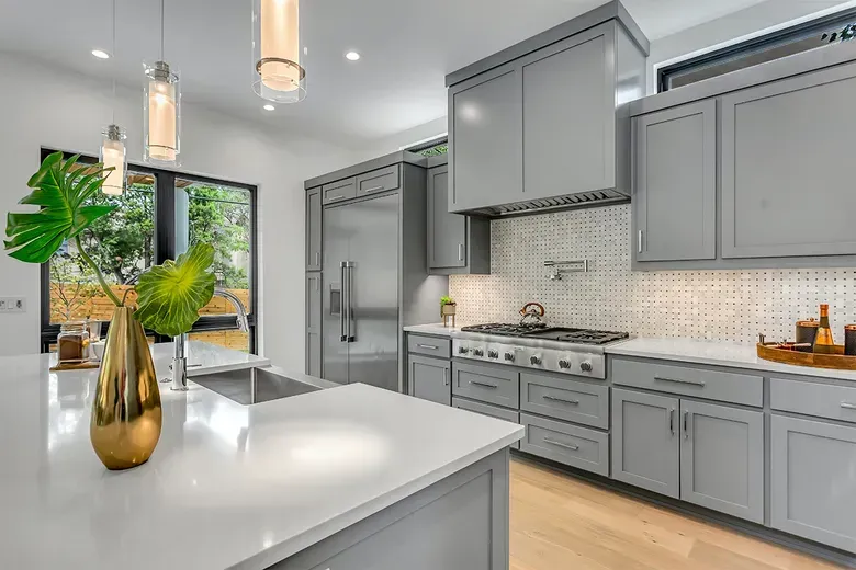 Bright remodeled kitchen with new flooring and pendant lighting