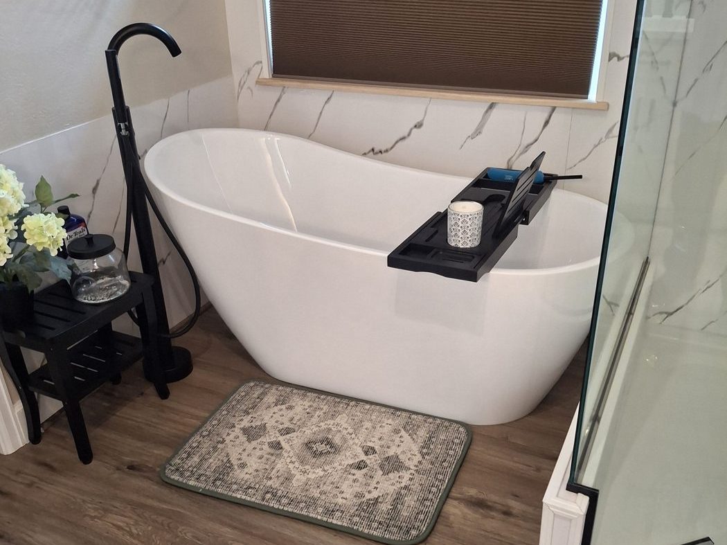 Remodeled bathroom with a freestanding soaking tub